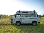 A small campervan parks up in the Big Sky campervan meadow (added by manager 04 Aug 2023)