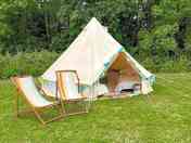 Belle tent surrounded by greenery