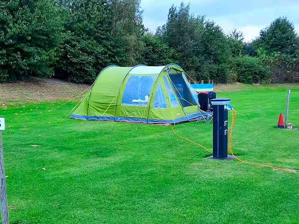 Power optional cement/asphalt and grass tent or trailer tent site