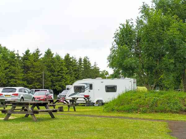 Electric hardstanding and grass touring pitch