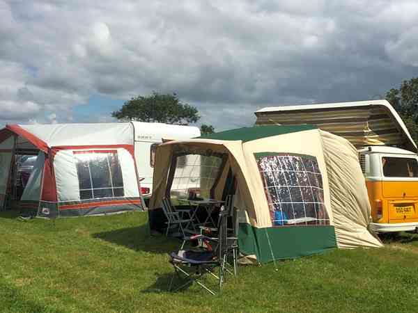Campervan and caravan in the main camping field Campervan and caravan in the main camping field