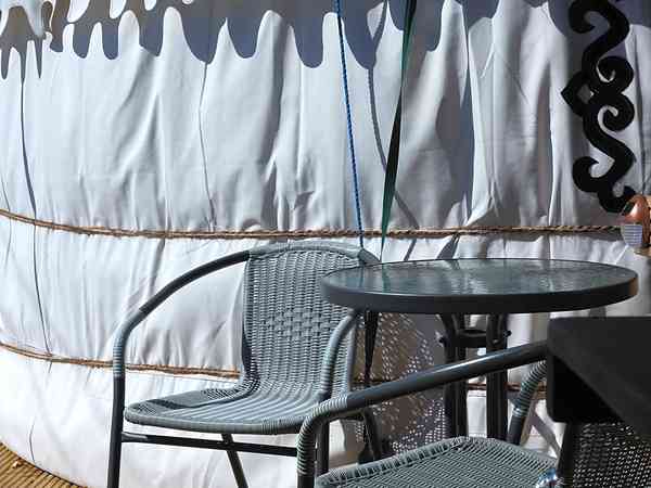 Decked area with patio table and chairs Decked area with patio table and chairs