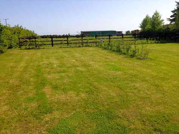 Powered grass and sand tent or trailer tent site