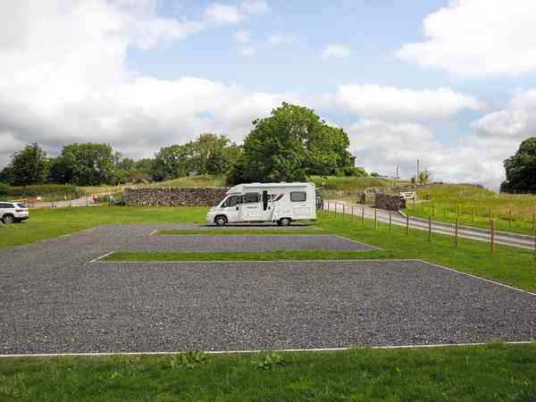 Primitive cement/asphalt and grass travel trailer site (maximum 2 adults)