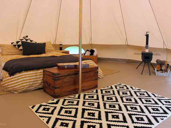 Bell tent with woodburning stove, logs and bed Bell tent with woodburning stove, logs and bed