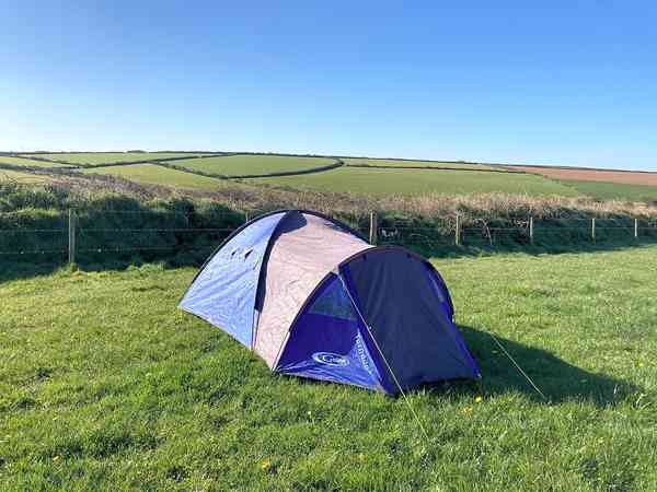 Non-electric grass and earth tent pitch