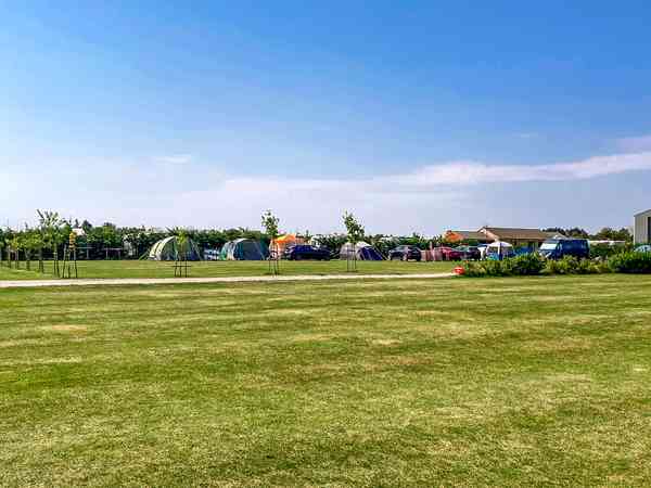 Powered grass tent site
