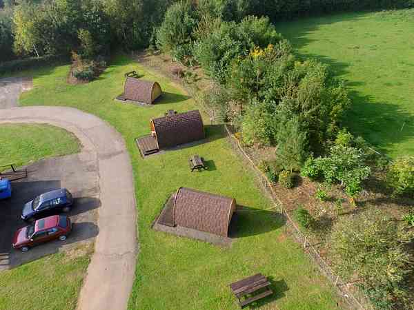 The camping pods are at the top of Rally field. The shower block is in front of Pods by the parking The camping pods are at the top of Rally field. The shower block is in front of Pods by the parking