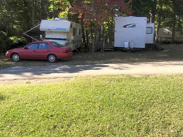 Powered grass and gravel travel trailer site (2 adults and 2 children, back-in)