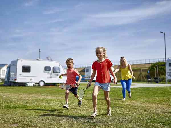 Children playing on the grass pitch Children playing on the grass pitch