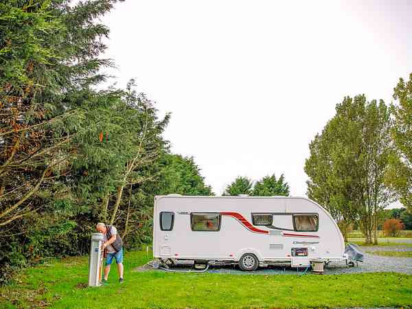 Fully-serviced gravel and hardstanding touring pitch