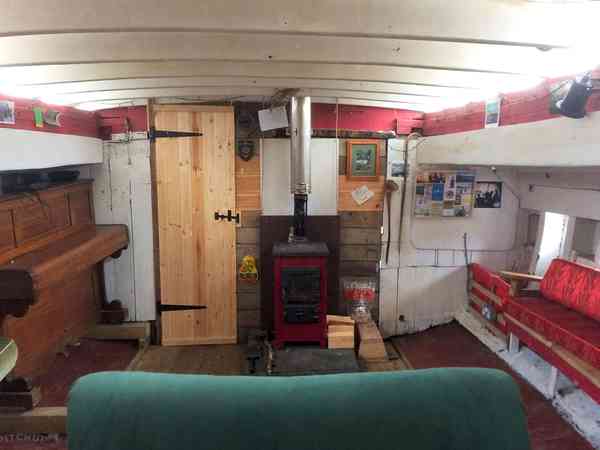 Interior of The Boy John, with woodburning stove and piano Interior of The Boy John, with woodburning stove and piano