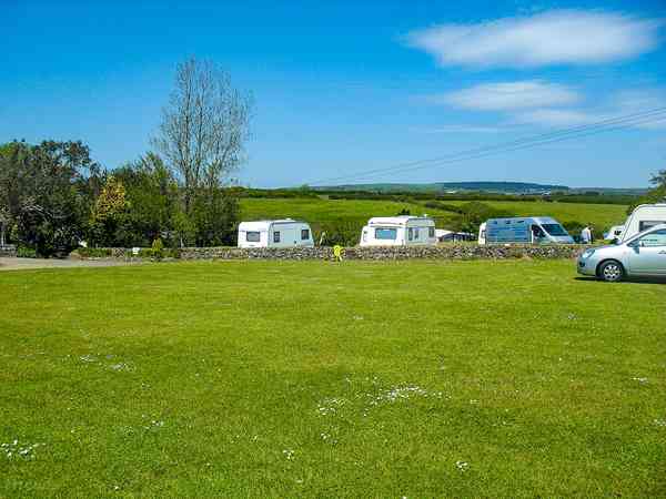 Non-electric grass touring caravan pitch (2 adults and 2 children)