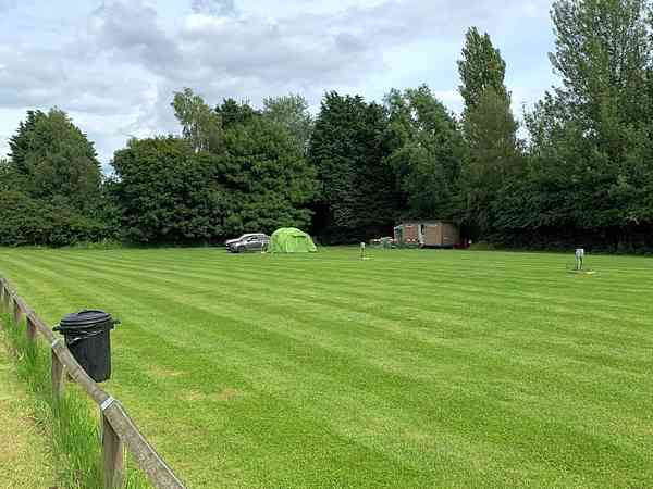 Powered grass tent or trailer tent site