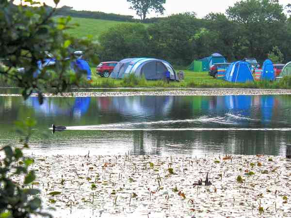 Electric hardstanding and grass pitch (lake view)
