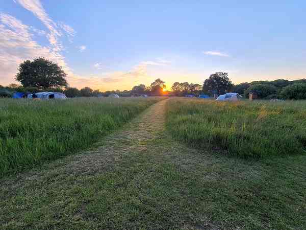 Unpowered grass tent or campervan site (private bathroom amenities)