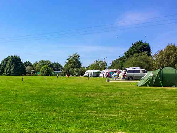 Powered grass tent site