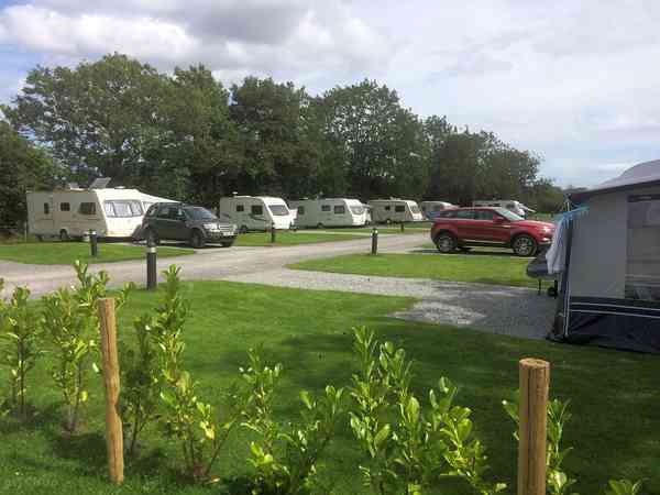 Fully-serviced hardstanding and grass touring pitch