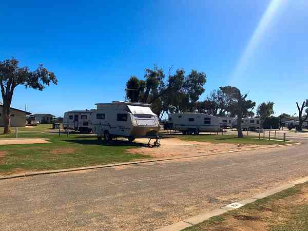 Fully-serviced gravel and sand touring caravan pitch
