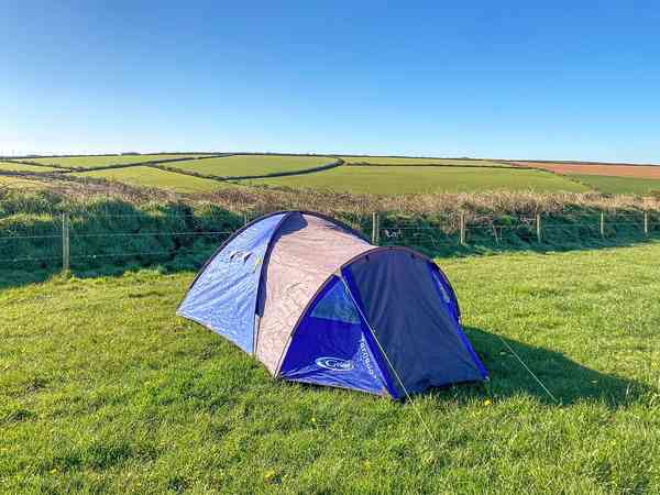 Non-electric grass and earth tent pitch