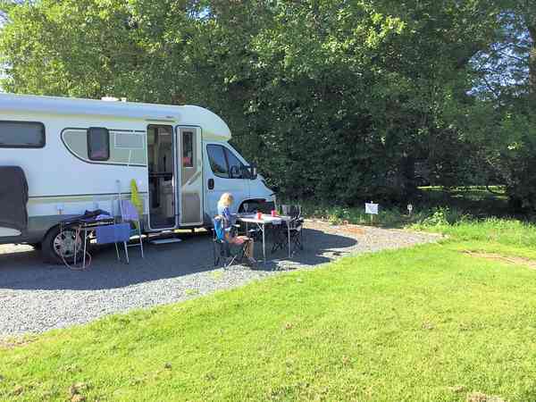 Primitive asphalt and grass RV site