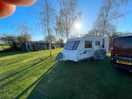 Other side of a caravan on a grass pitch