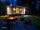 Evening setting of hut and fire pit.