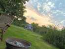 Sunset clouds. a fire pit is provided at each pitch, and furniture can be moved around as necessary.