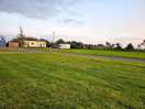 Some of the site including mobile home and caravan for hire. the blue building is 2 separate toilets