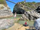 Beach with rock pools and restaurants and shops around