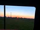 Sunset from campervan window on pitch.