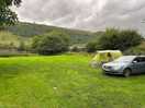 Cosy field with peaceful scenery. photo shows field with one car and medium tent.