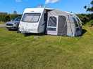 Caravan all set up on the pitch.
