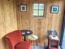 Inside the hut: comfy chairs and log burner