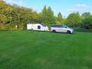 Grass touring pitch with electric hookup which was not needed as pod is totally off grid.