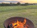 Warming up by camp fire