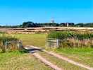 Entrance to second field and roch castle on the horizon