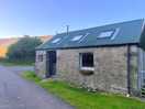 Old school house at site entrance now bothy barbers and hairdressing
