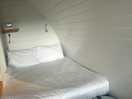 Comfy double bed with shelf and lamps