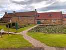 Next to farm house on pitch