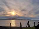 Beautiful sunset over the water and mountains