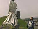 Castle ruins in town with statue
