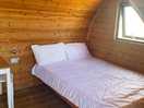 Inside camping pod, double bed.