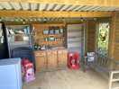 General hut, with freezer, local maps, book loan facilities, and various food products for sale.