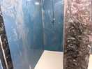 No door on shower or curtains on any showers