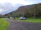 Motorhome hardstanding. long and water next to them.