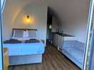 View inside with sitting area, space saving dining table, tv and kitchen