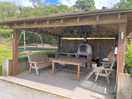 Pizza oven in covered seating area.