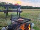 Bbq and bench within one of the pitches.