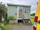 En-suite facilities. bath, shower, toilet. electric hook up. kitchen behind this and bins.